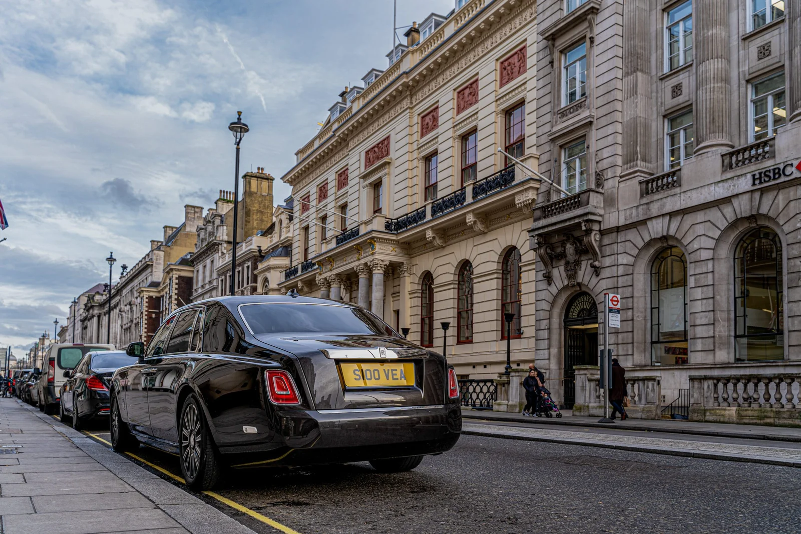 Black Rolls-Royce luxury car parked on historic London street