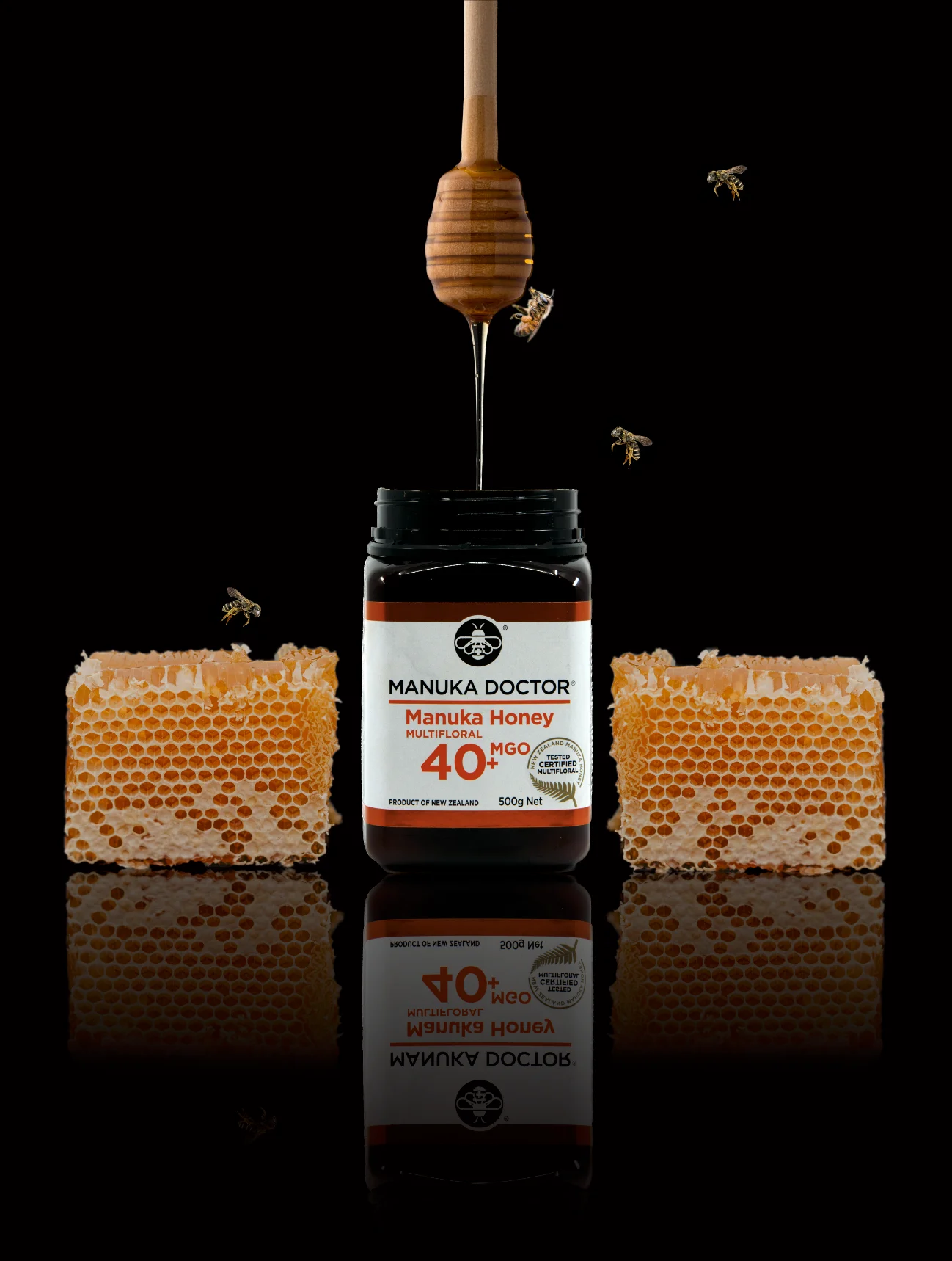 Manuka Doctor honey jar with honeycomb and bees on black background