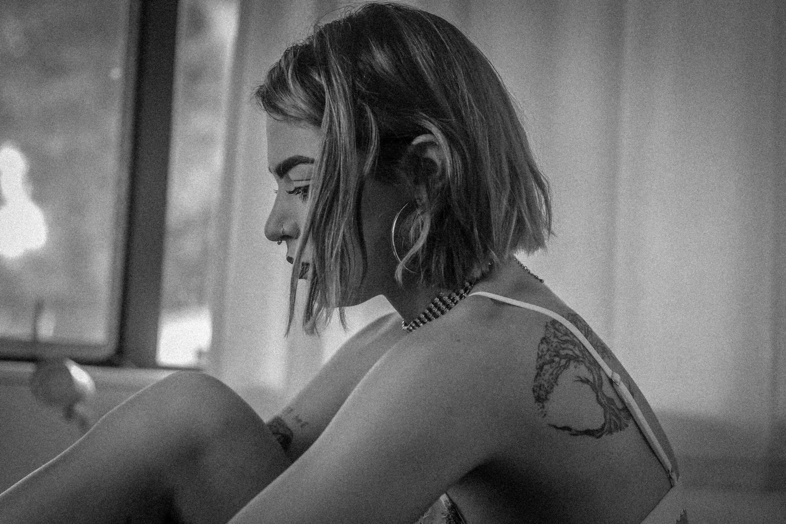 Black and white portrait of woman with tattoo