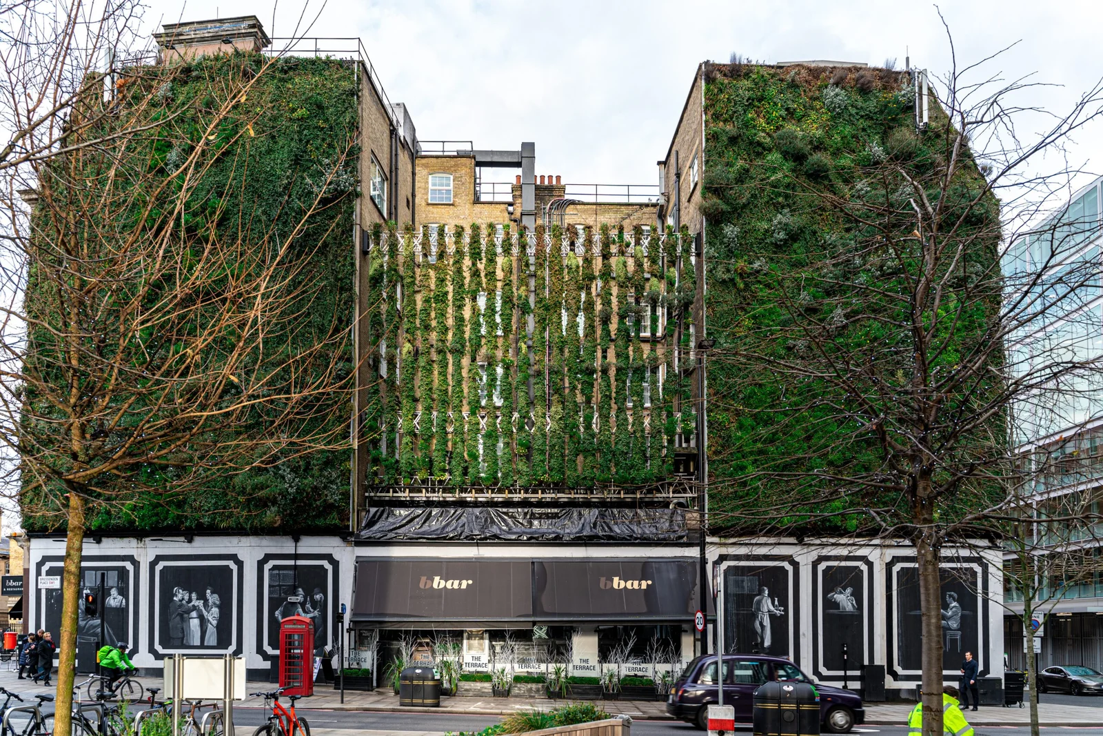 Modern building with vertical green garden wall and 6bar restaurant signage