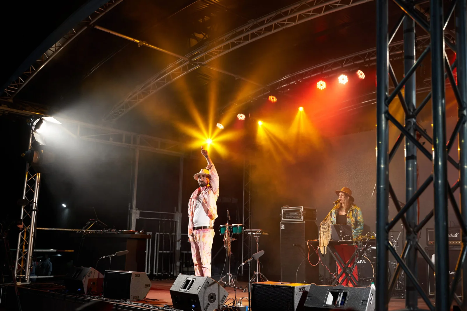 Musician performing on stage with spotlights