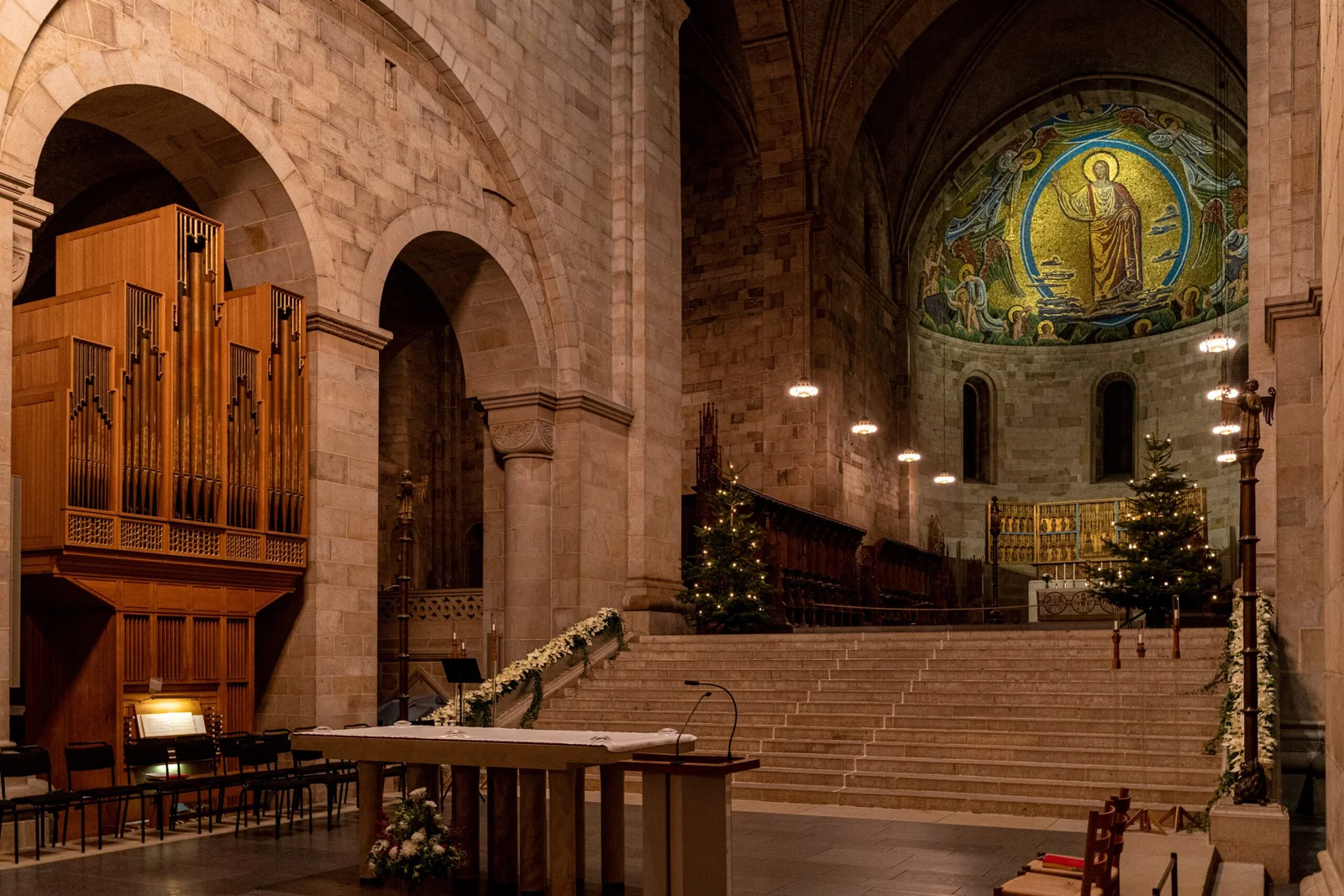 Interior of a grand church with a mosaic and pipe organ
