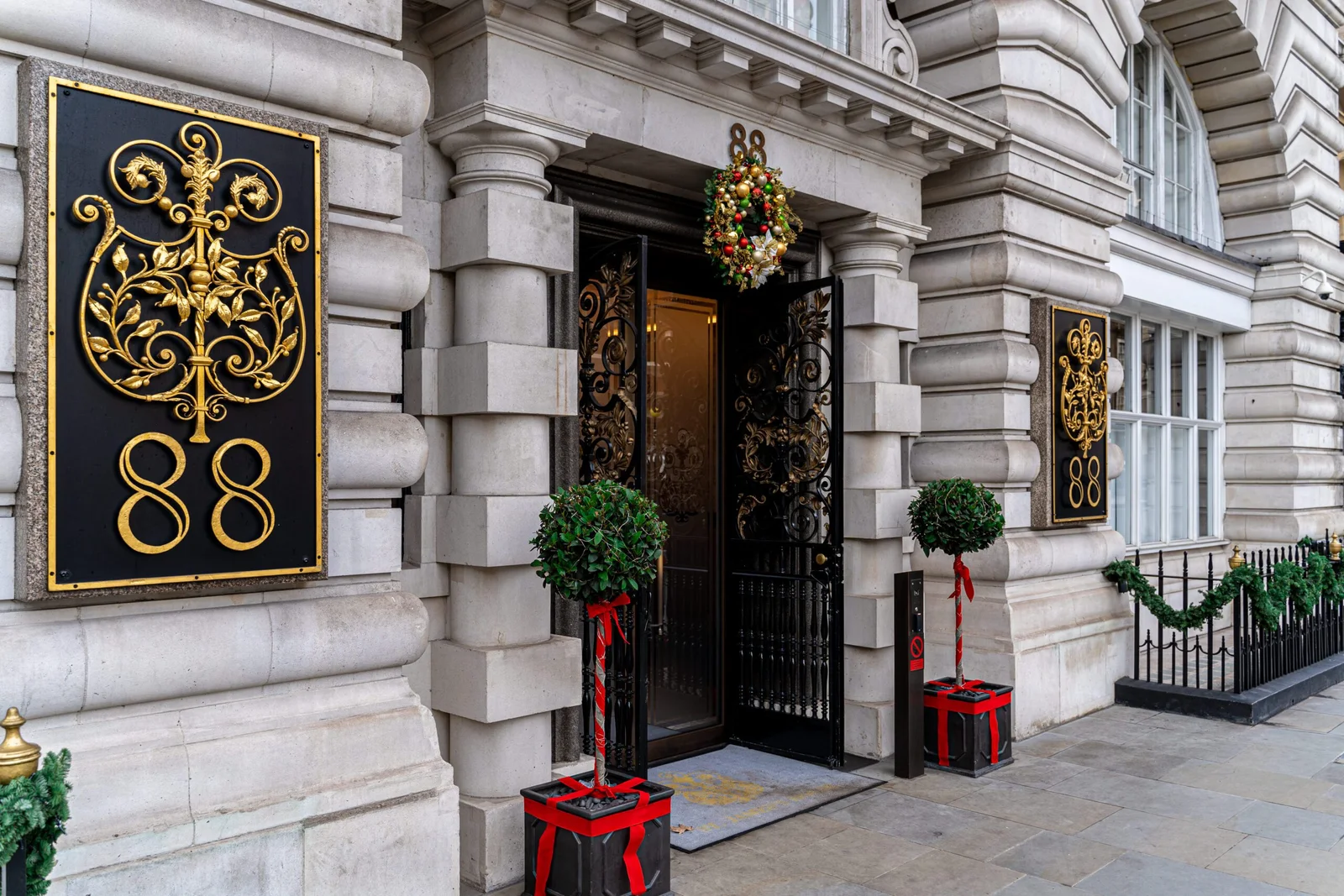 Ornate building entrance with number 88 and Christmas decorations