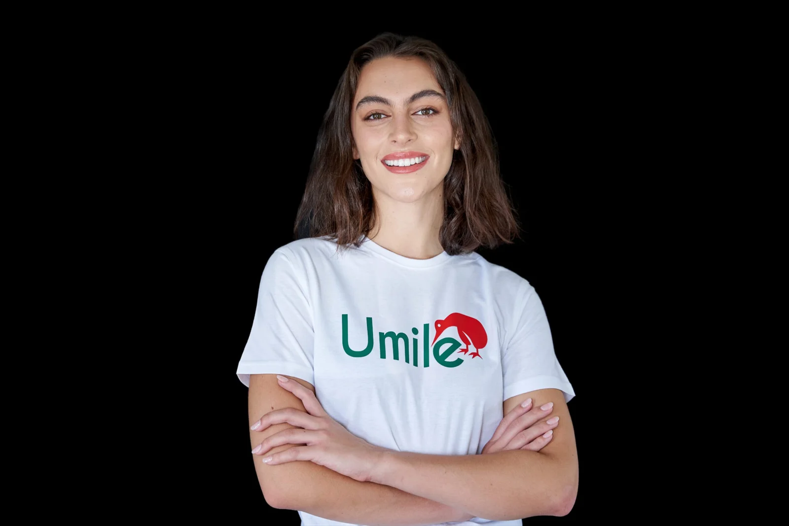 Smiling woman in a white Umile t-shirt with arms crossed
