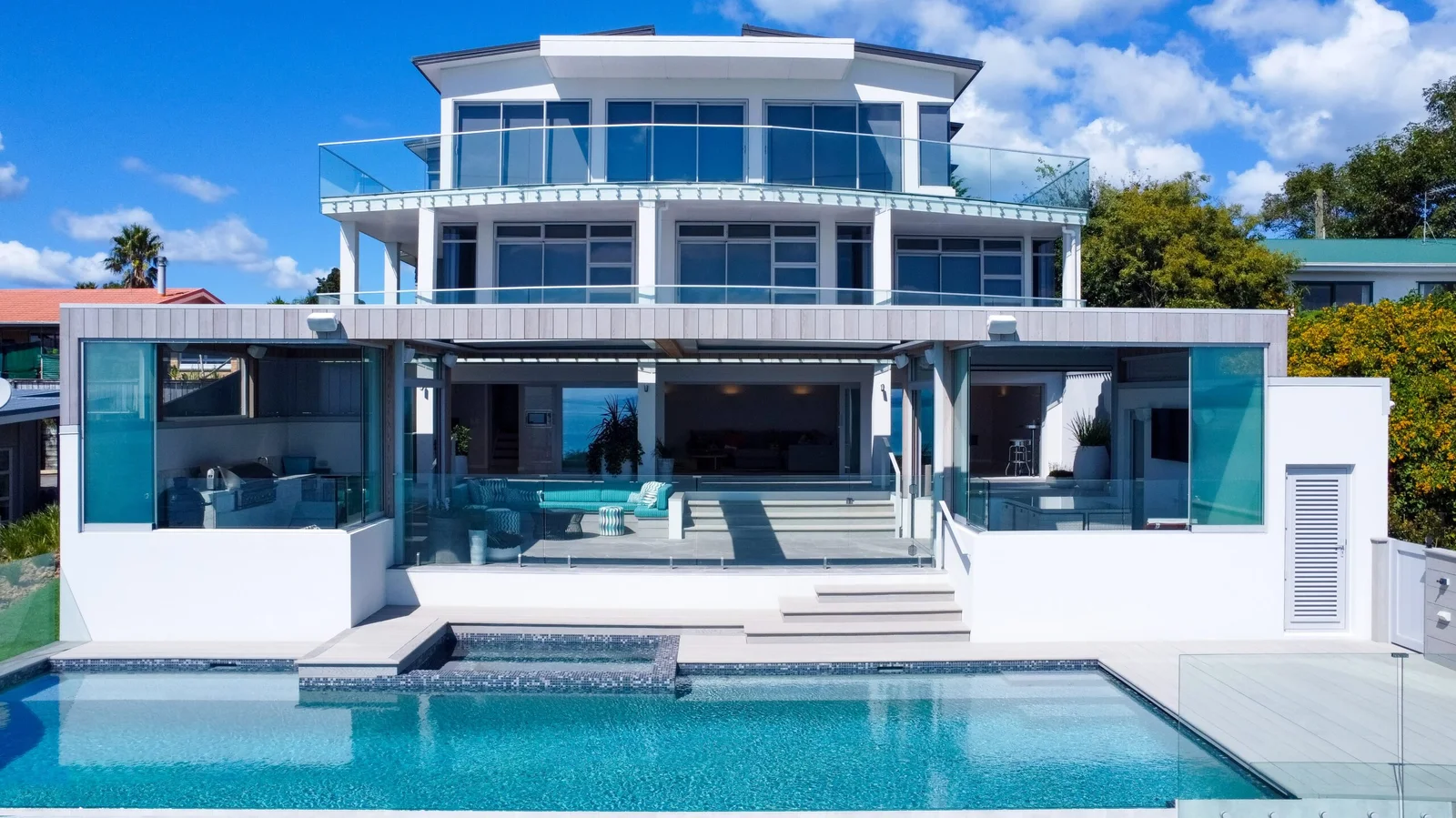 Large modern white house with an infinity pool