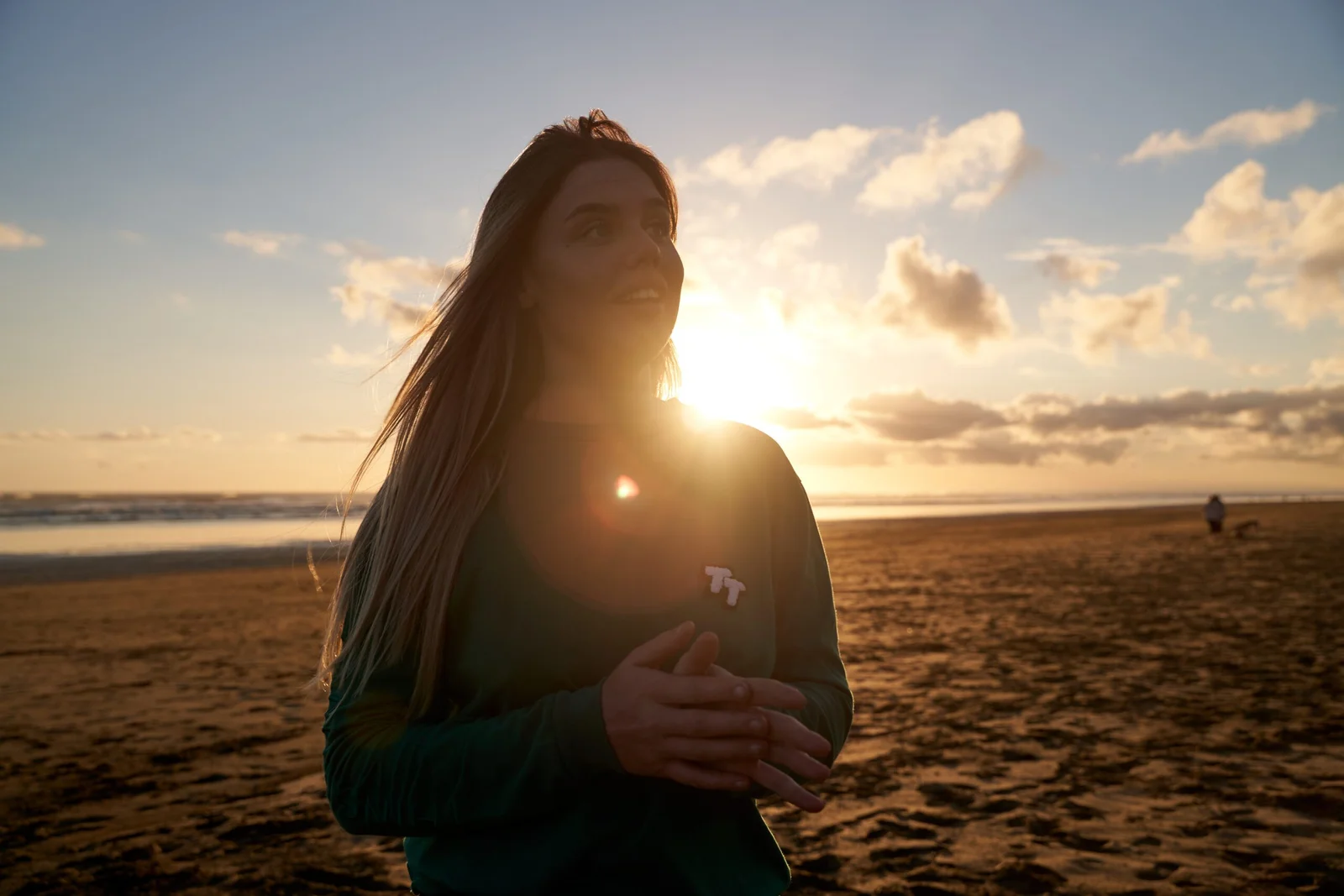 Young woman on a beach at sunset