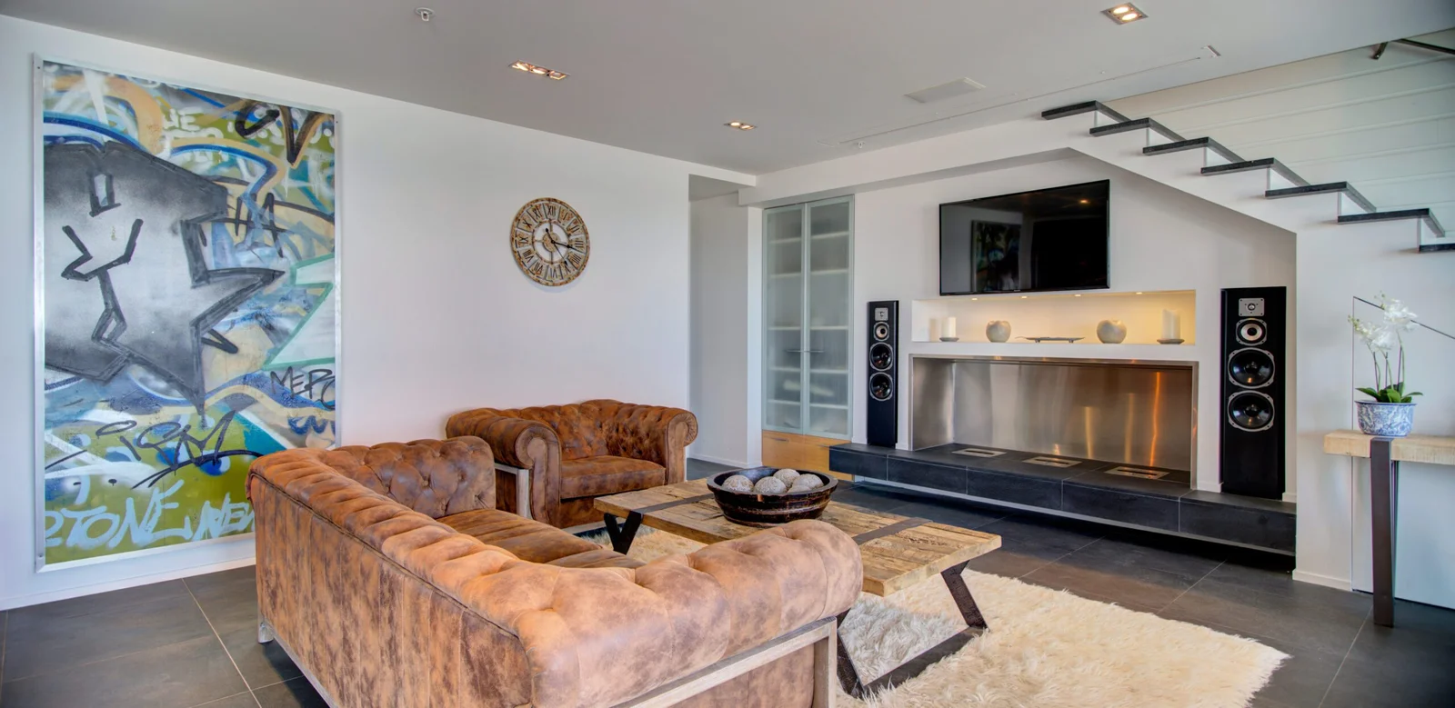 Modern living room interior with leather sofas and abstract art