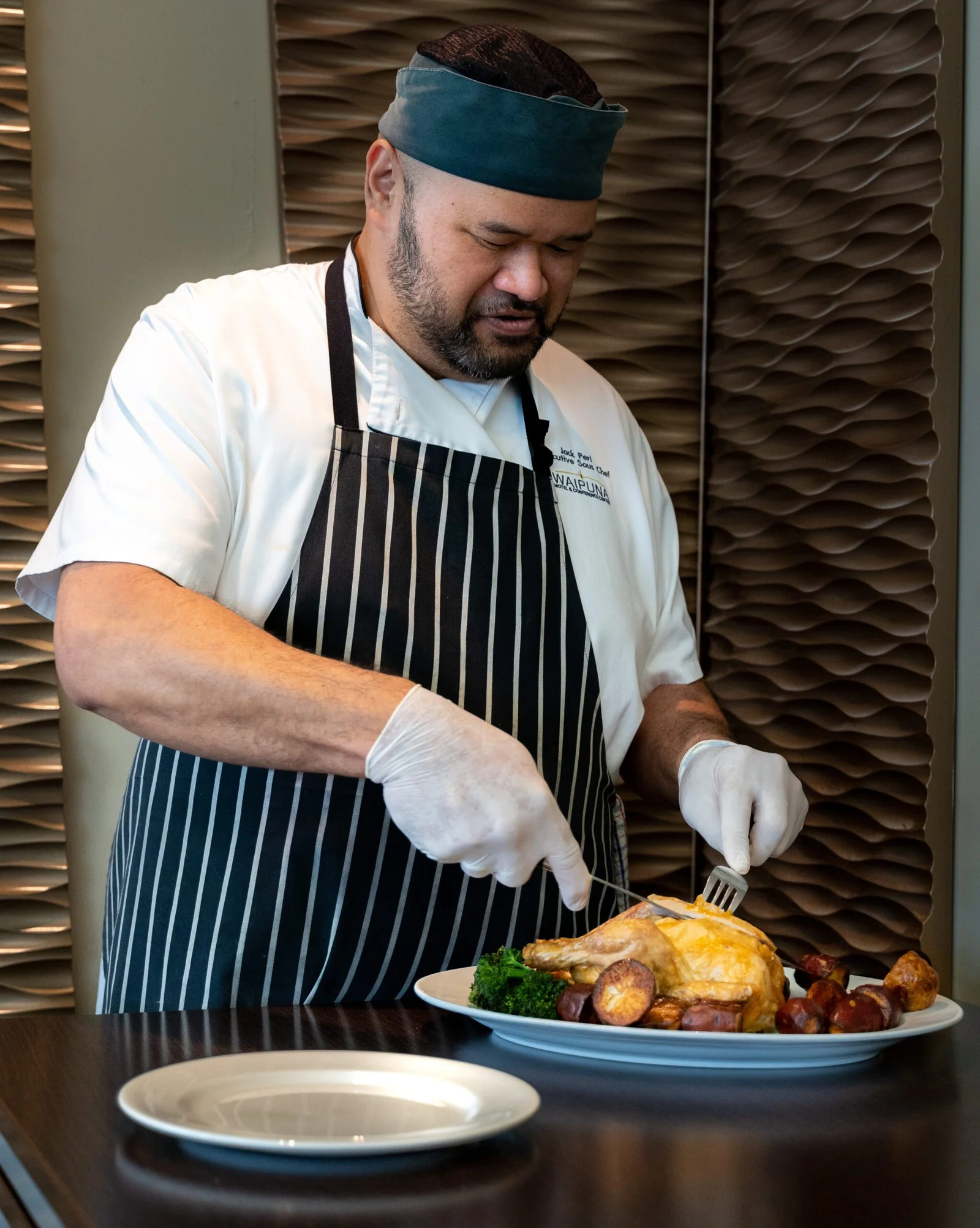 Chef carving roasted chicken