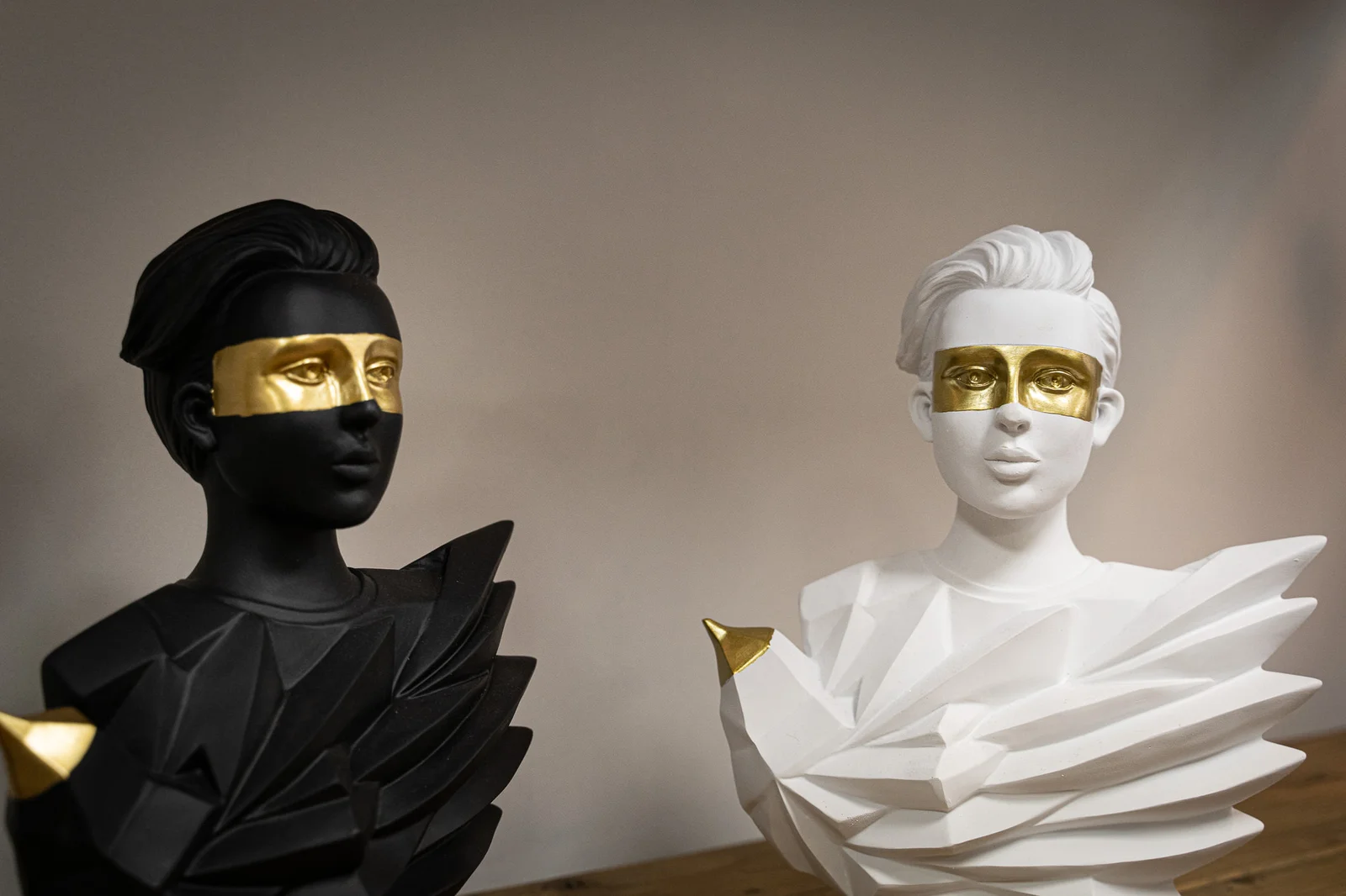Two abstract busts with gold masks