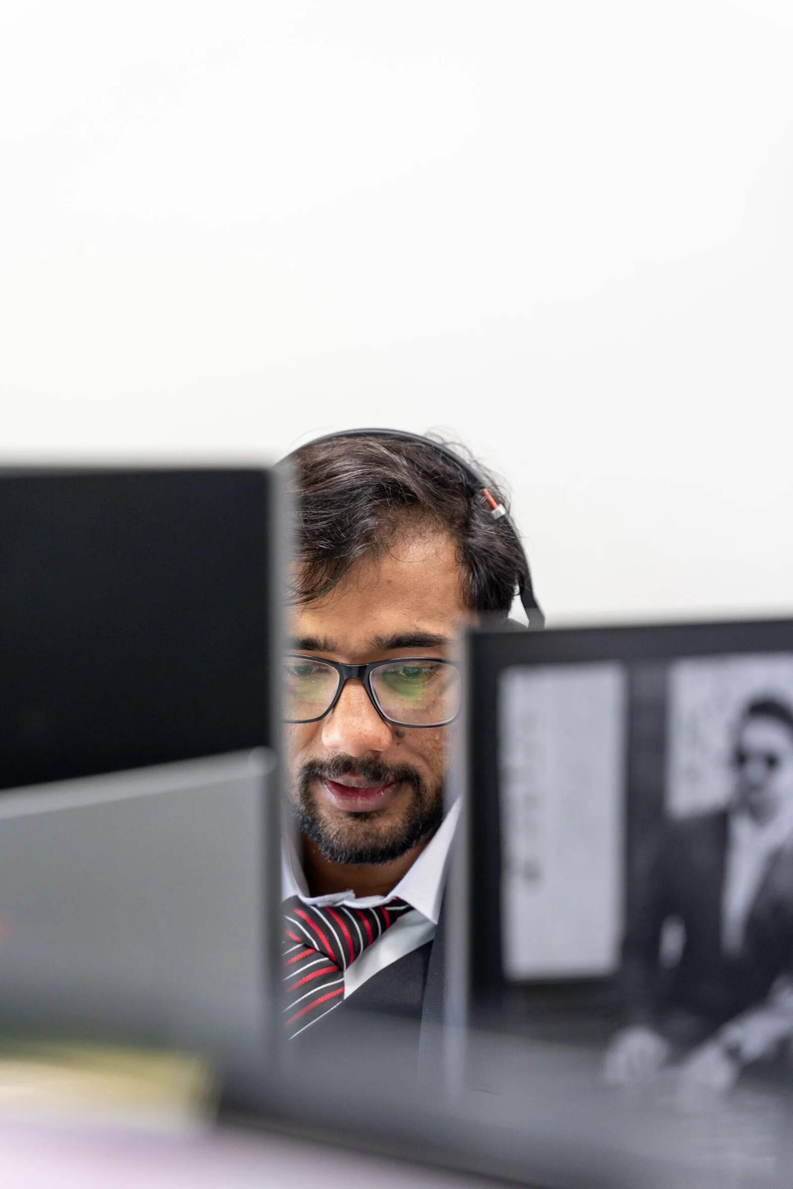 Man with glasses looking at computer