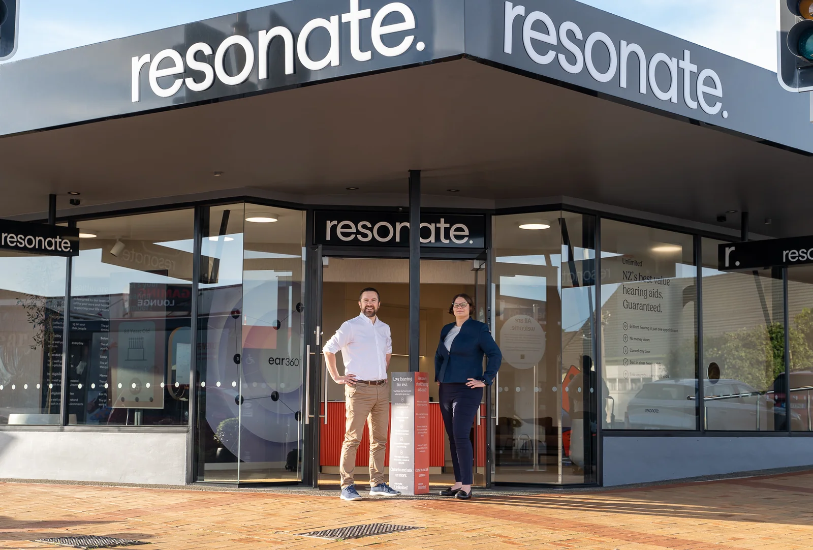 Two professionals in front of Resonate building