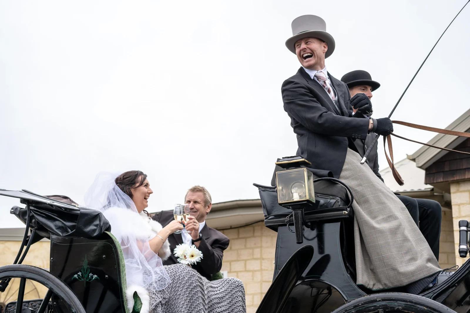 Bride and groom in horse-drawn carriage