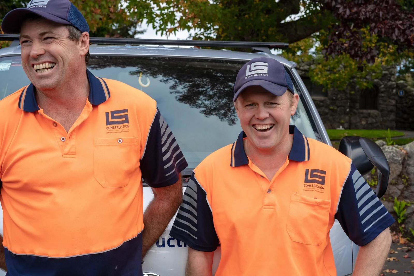 Two construction workers smiling
