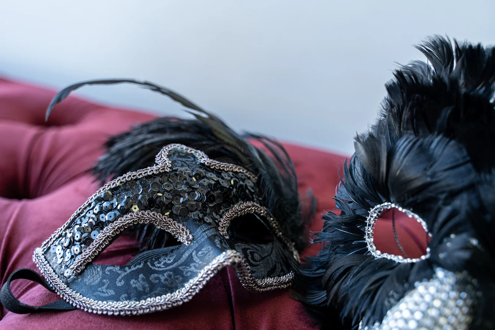 Ornate black masquerade masks with feathers and sequins