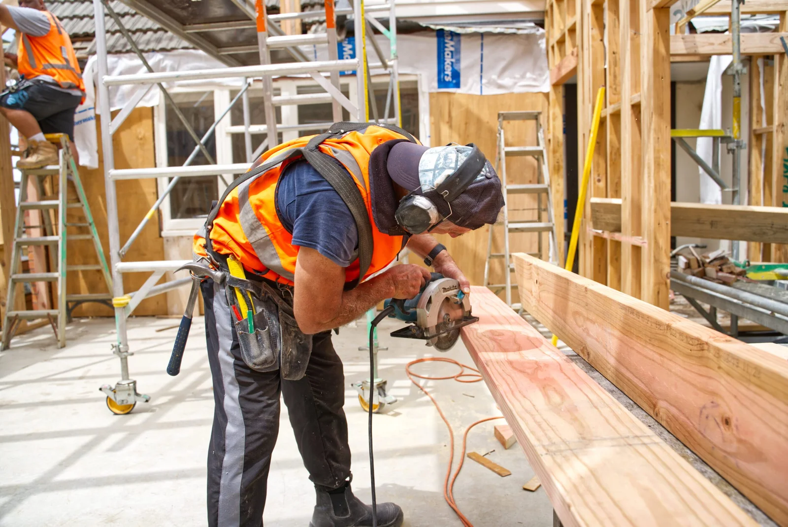 Construction worker using circular saw