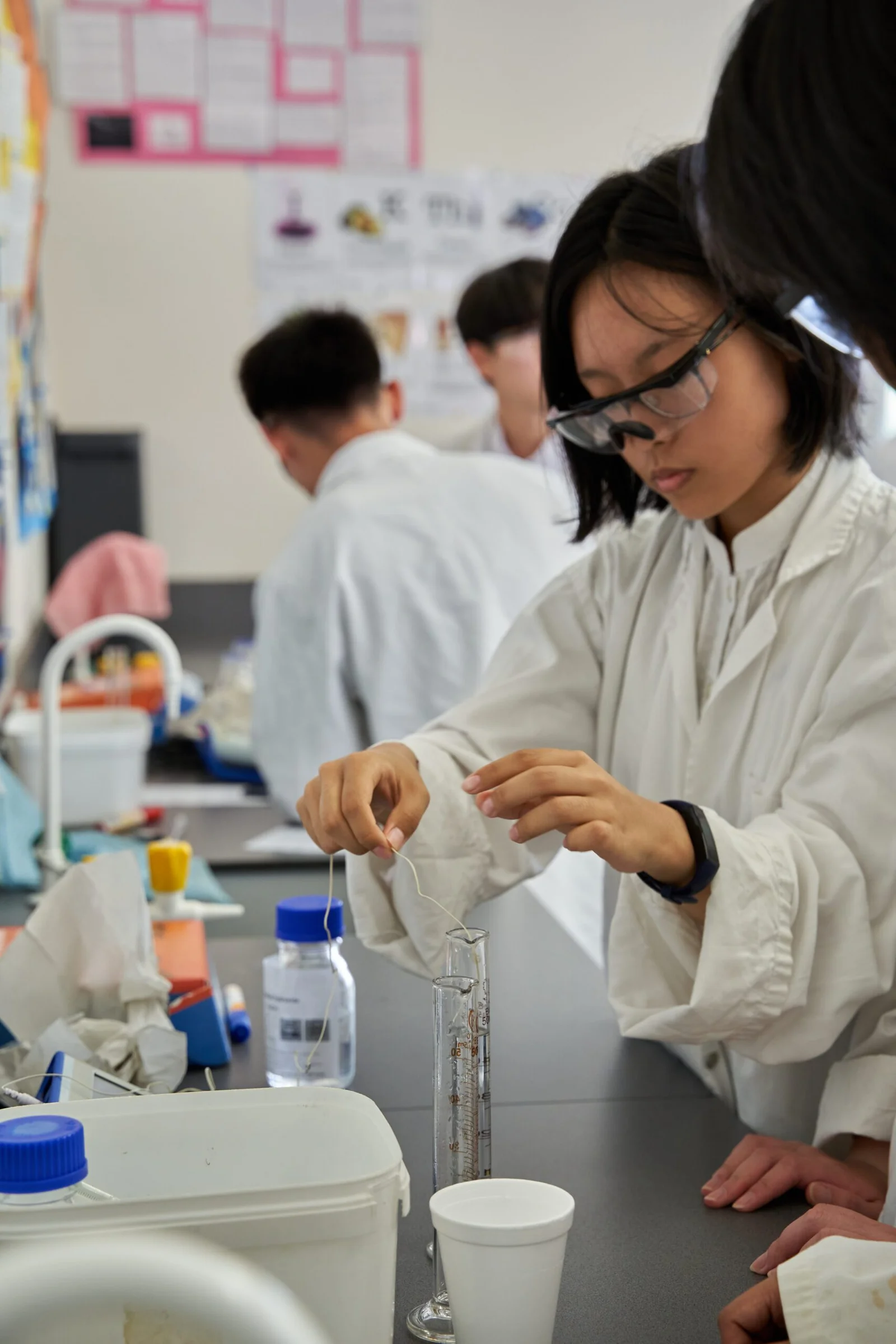 Female scientist in white lab coat working with laboratory equipment