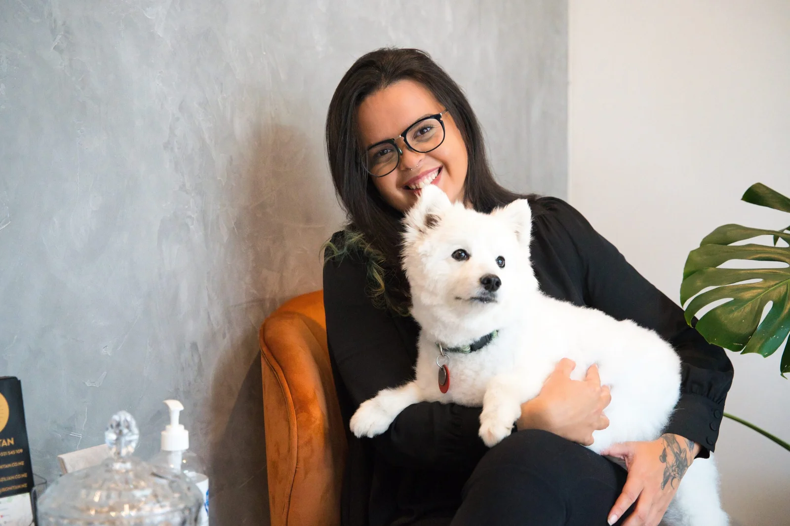 Woman holding a white dog