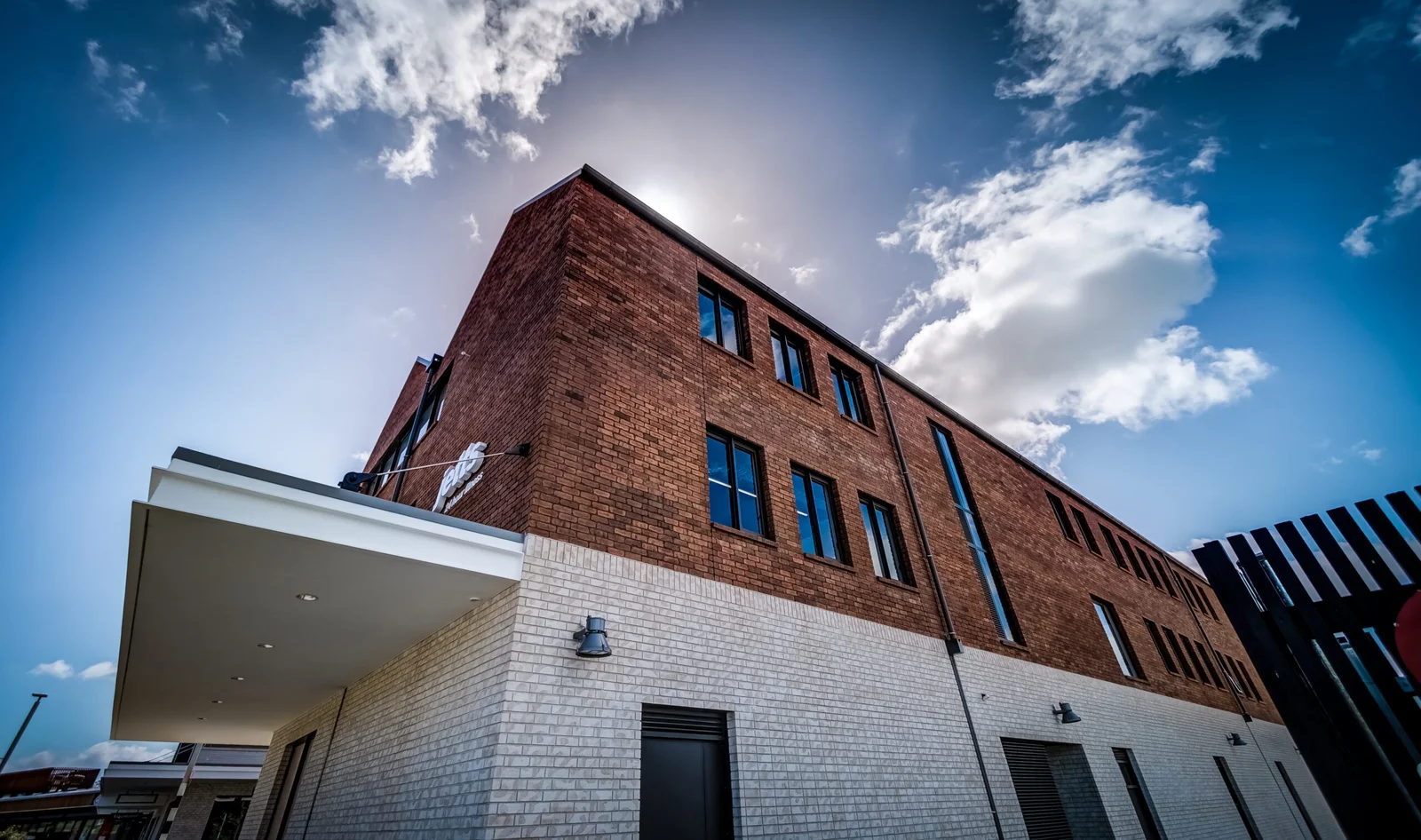 Modern brick building exterior with dramatic sky