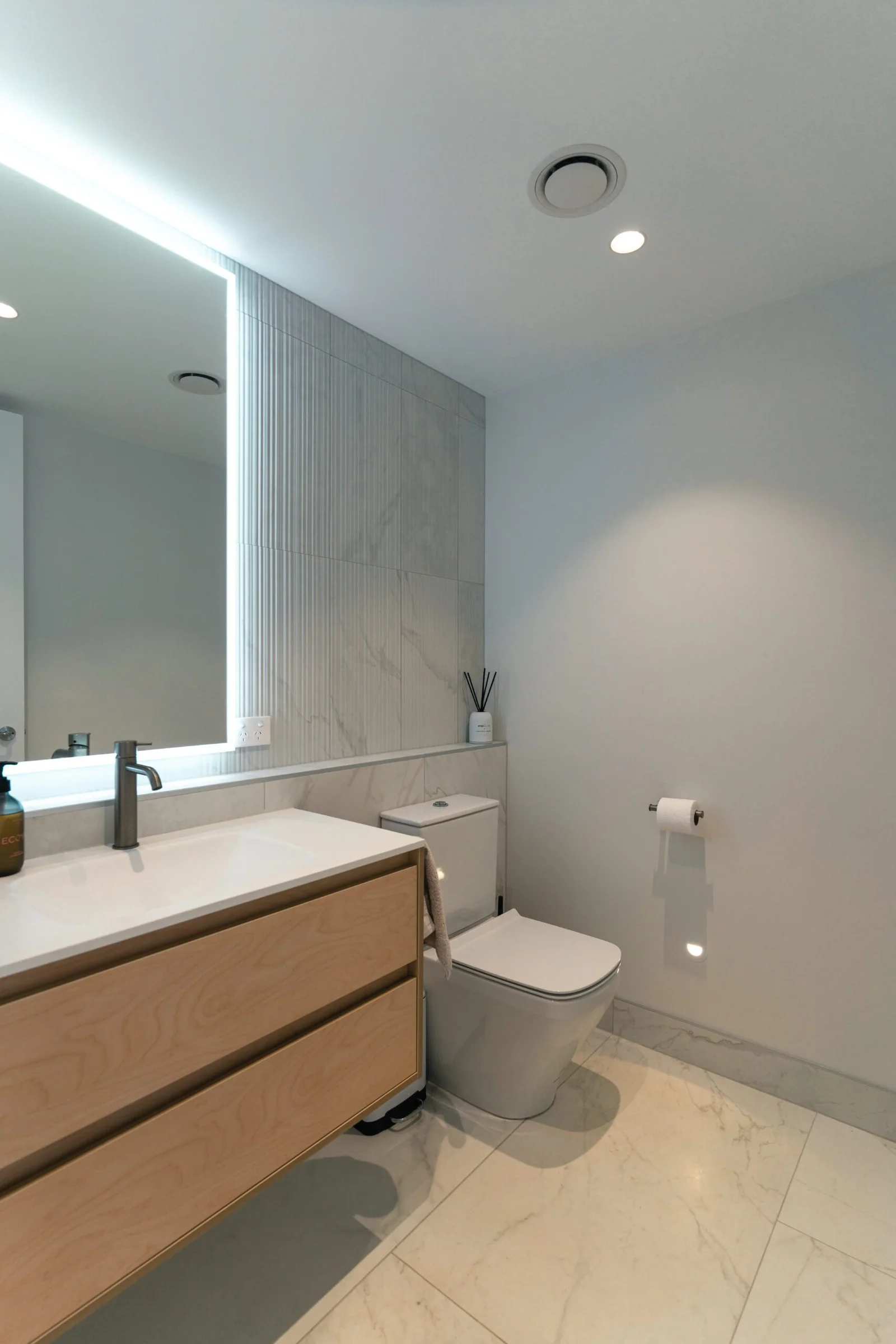 Modern bathroom interior with marble surfaces and contemporary fixtures
